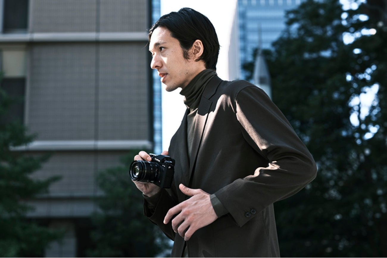 A Man Holding Fujifilm X-T5 Camera with 18-55mm Lens