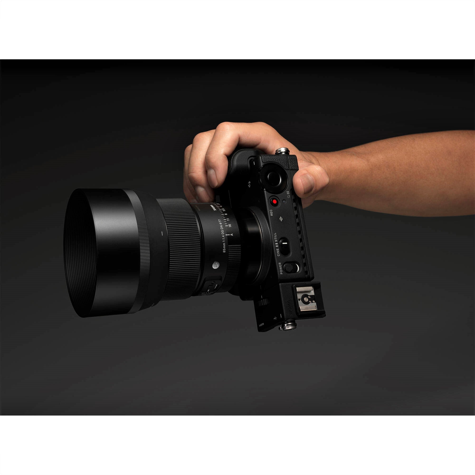 Hand Holding Sigma 85mm F1.4 DG DN Art Lens for Leica L
