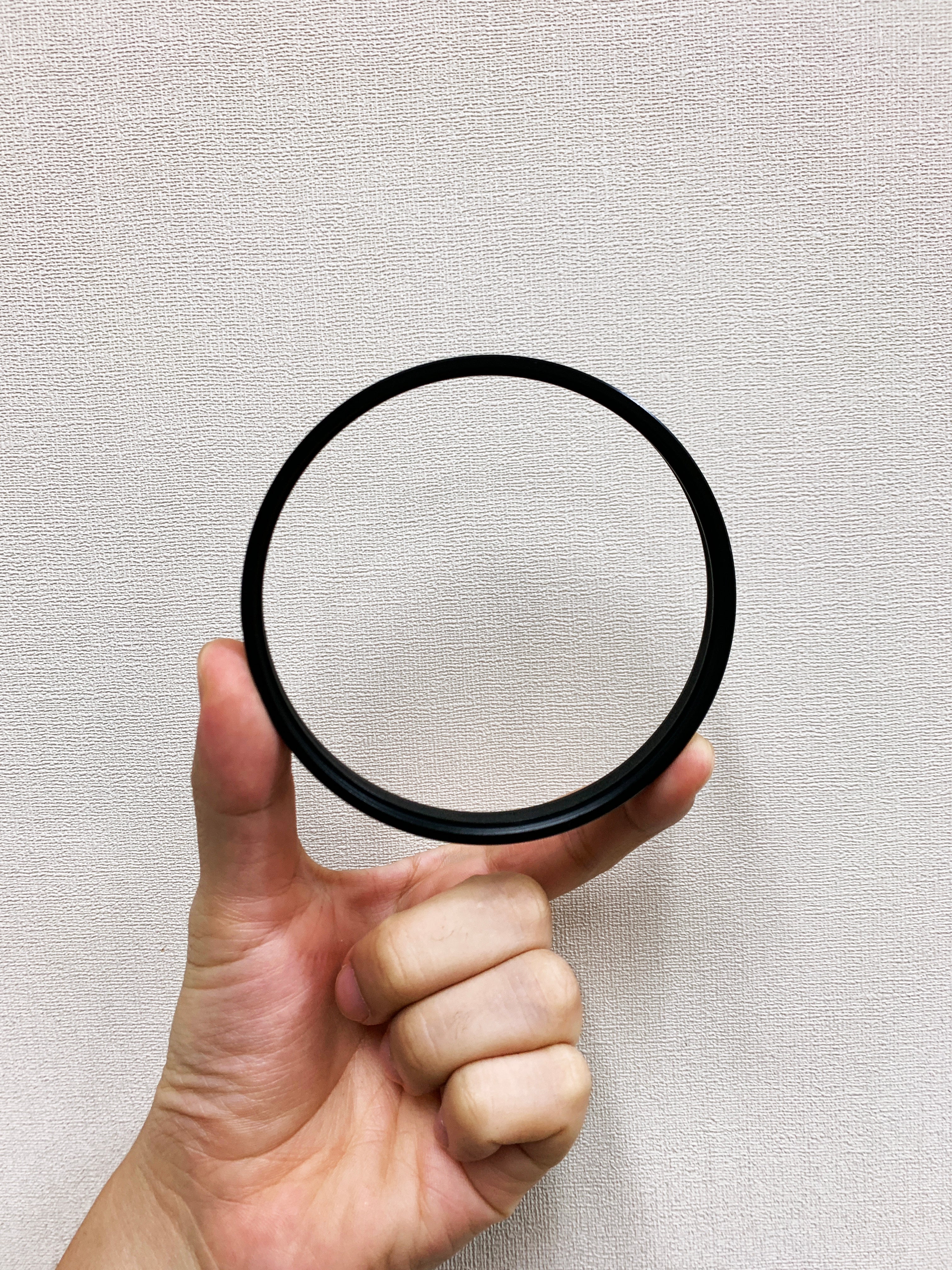 Hand holding a Vazen Step-up Ring for 95mm Screw-in Filters for Vazen 40mm Lens