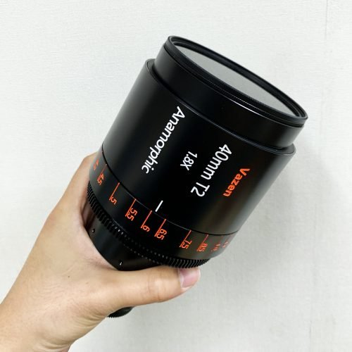 Hand holding a Vazen Step-up Ring for 95mm Screw-in Filters Attached to a Vazen 40mm Lens